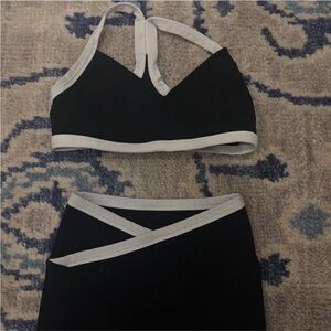 Black and white Beyond Yoga sports bra and leggings set.